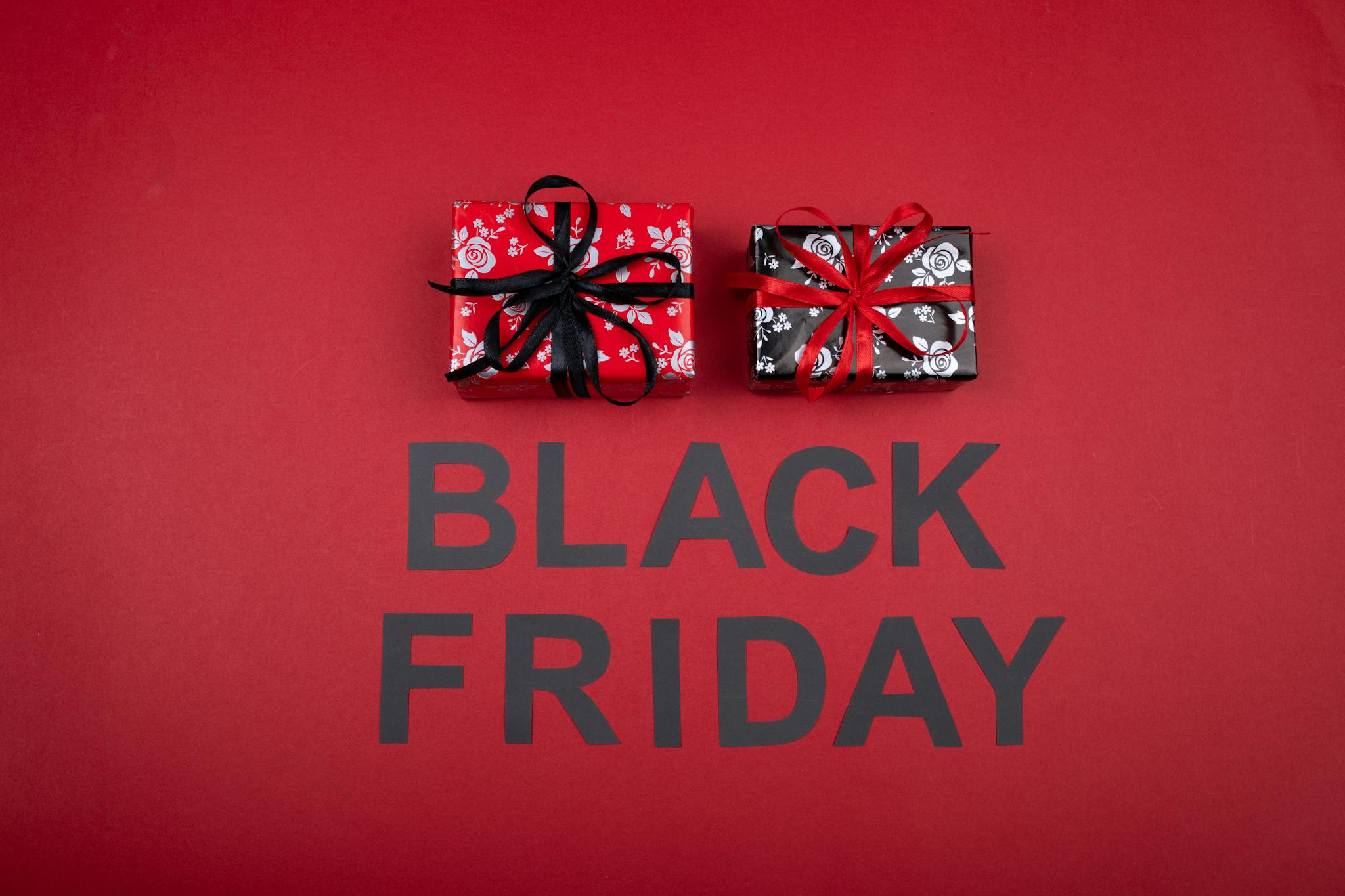 Festive Black Friday promotion with gift boxes on a vibrant red background.